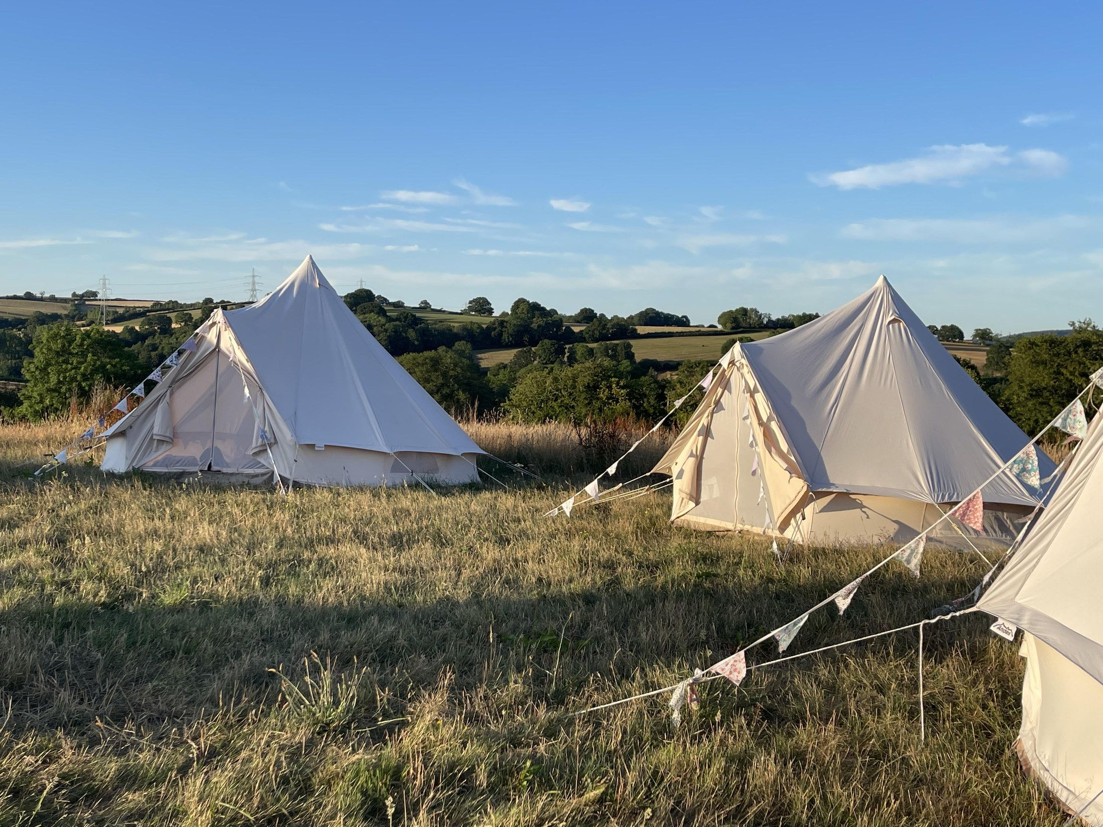 Bell tents set up on the land for overnight team retreats