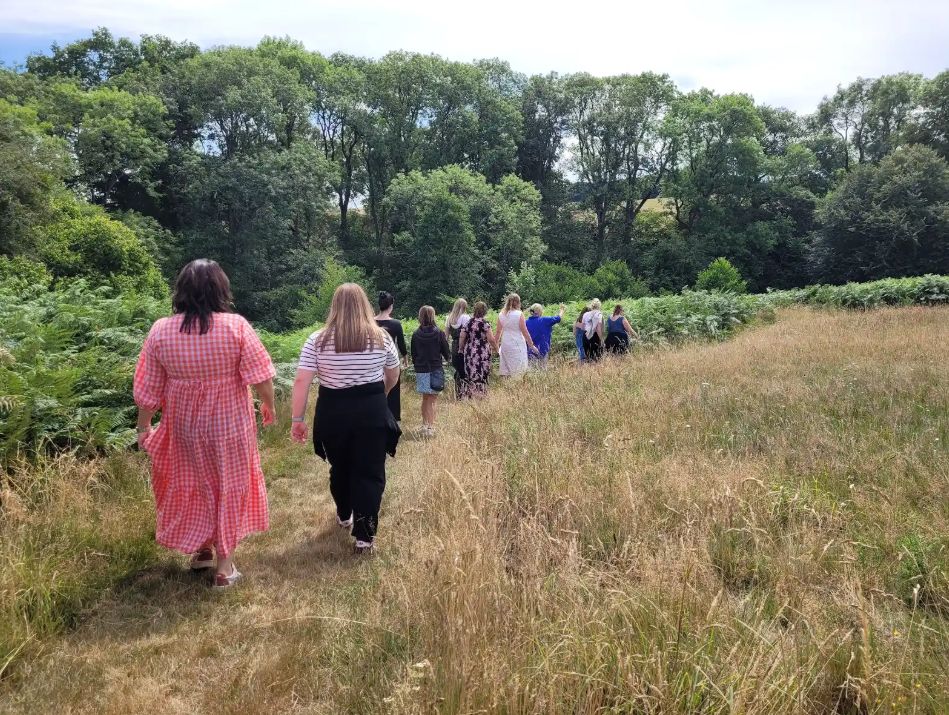 Team walking through the landscape at the Grange Project